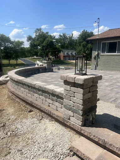 Curved patio with pillar wall - completed hardscape project in St. Louis