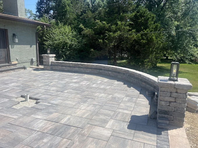 Curved paver patio with wall - completed hardscape project in St. Louis