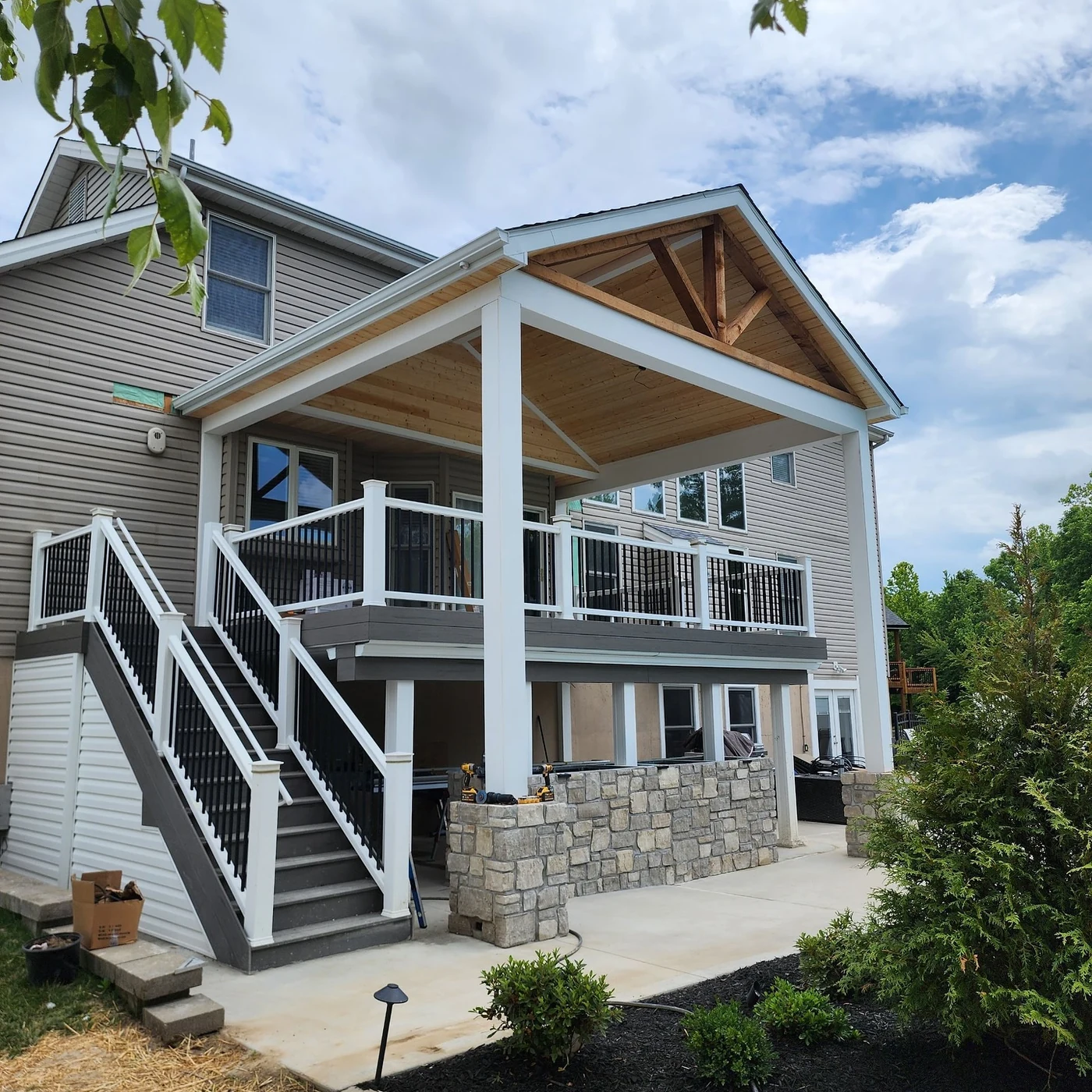 Covered elevated deck with stone bar - completed hardscape project in St. Louis