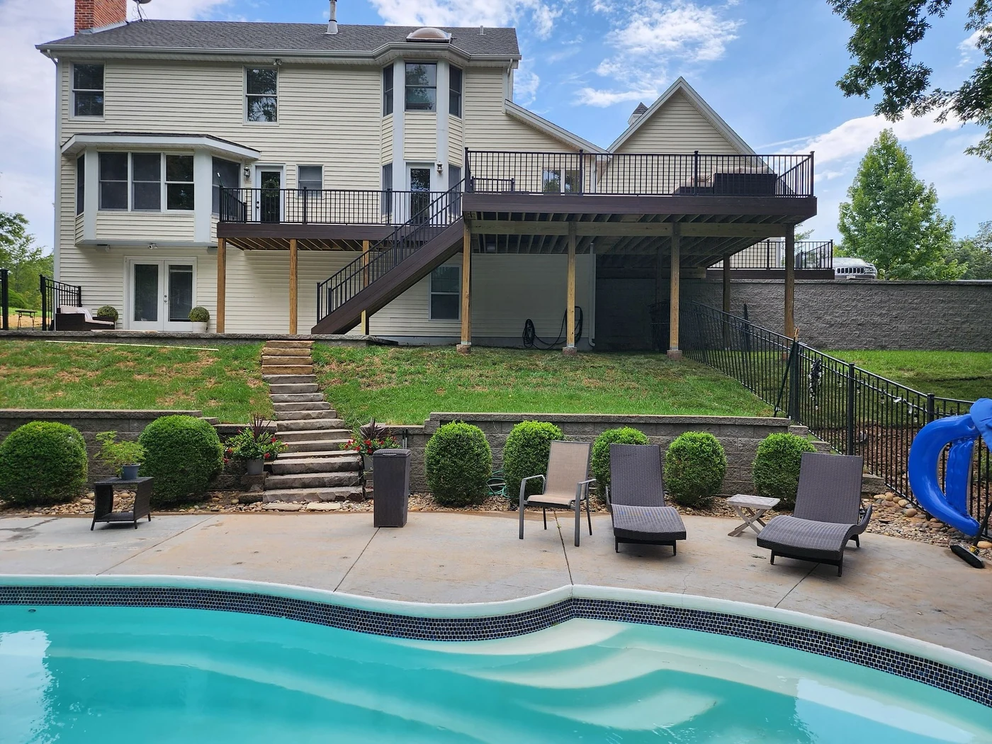 Large elevated deck over poolside wall - completed hardscape project in St. Louis