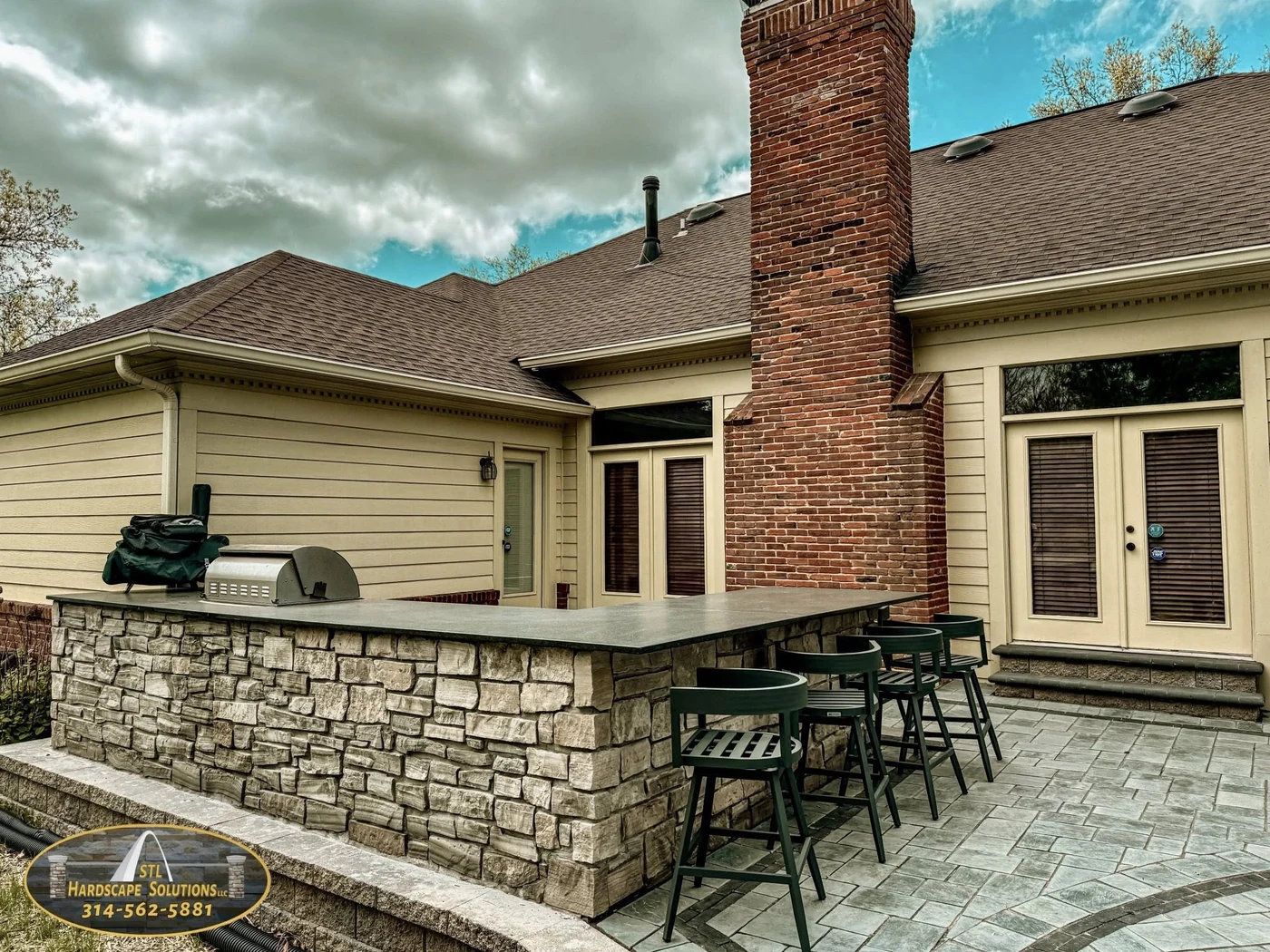 Stone outdoor kitchen bar - completed hardscape project in St. Louis