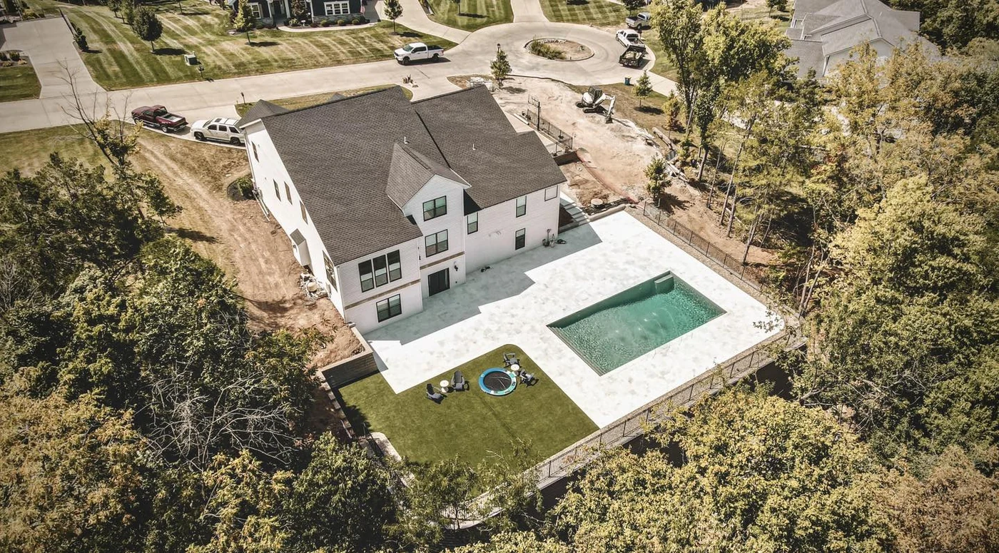 Modern pool with travertine deck - completed hardscape project in St. Louis