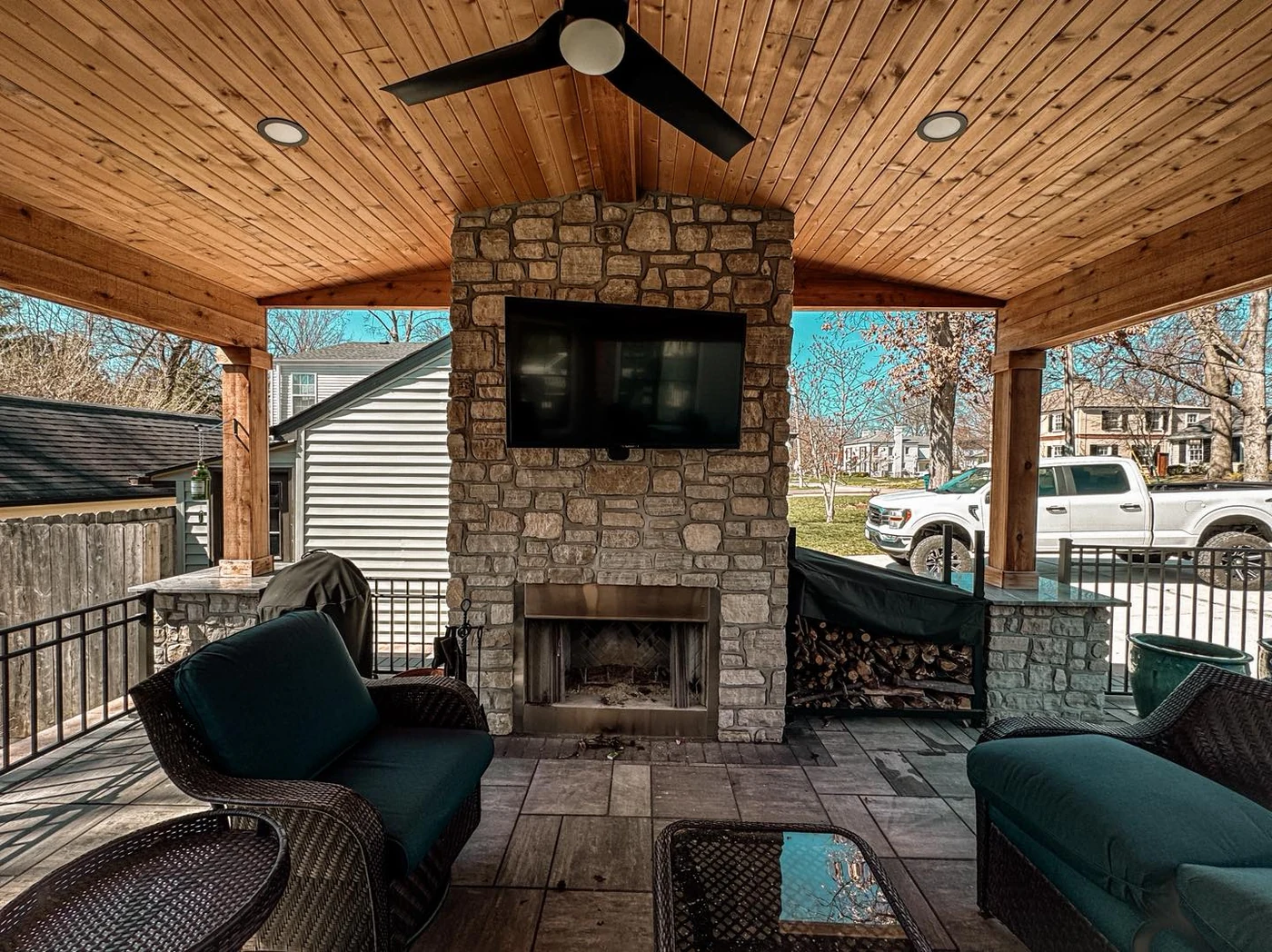 Covered patio with stone fireplace - completed hardscape project in St. Louis
