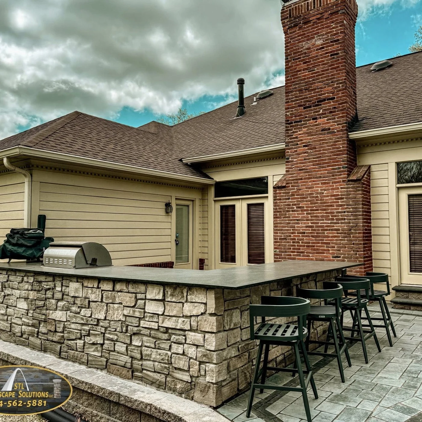 Stone outdoor kitchen bar - completed hardscape project in St. Louis
