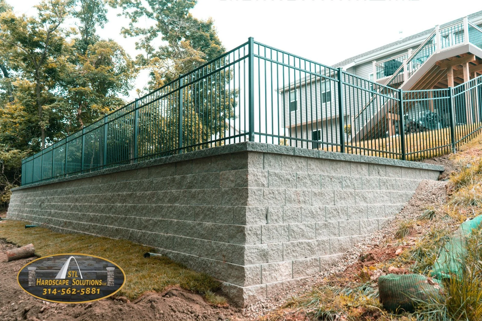 Custom structural retaining wall with black metal railings in St. Louis
