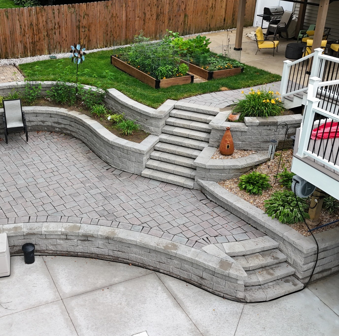 Multi-level paver patio with curved retaining walls and steps in St. Louis