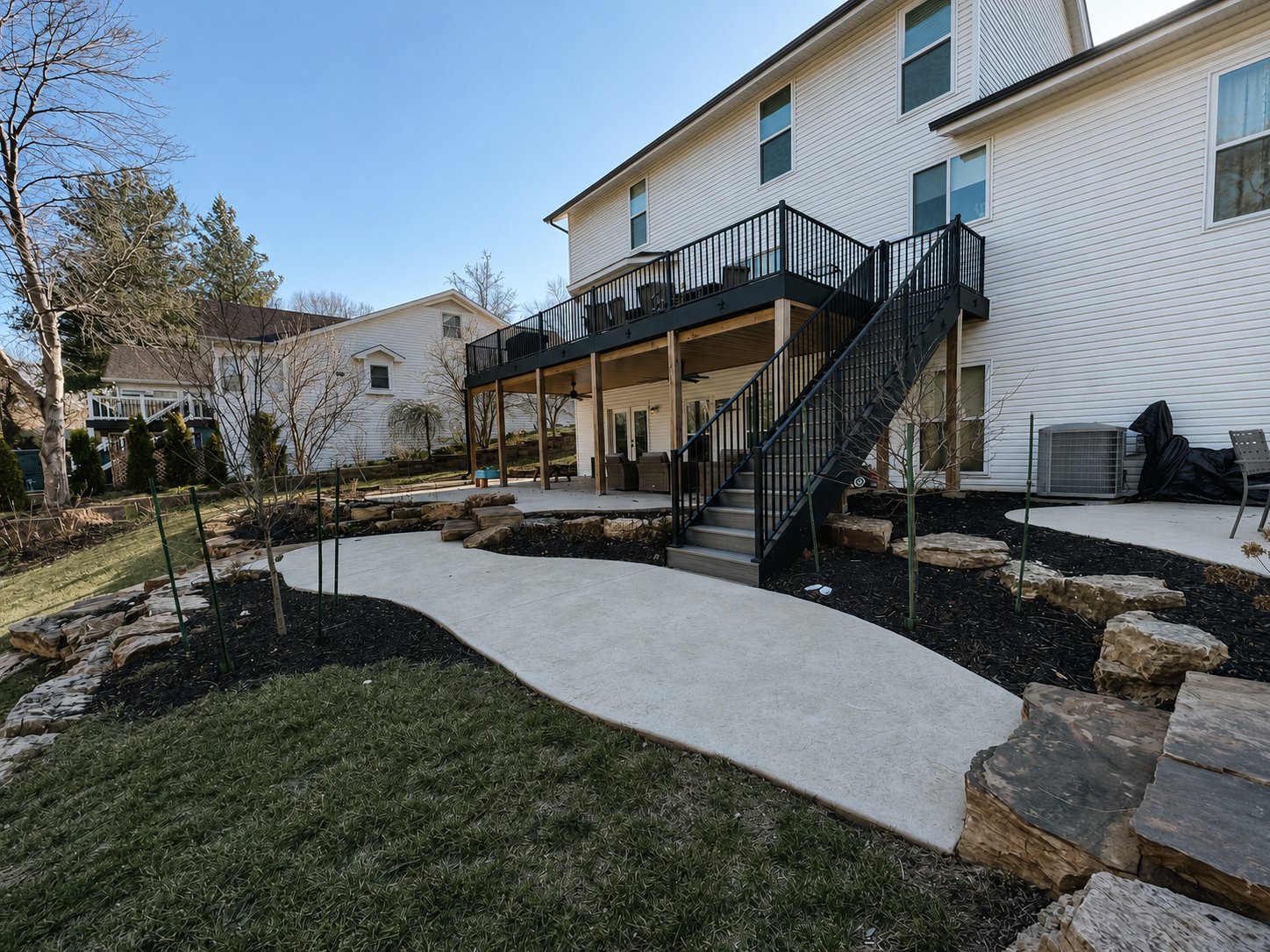 Luxury backyard outdoor living area with pergola and lighting in Pacific Missouri